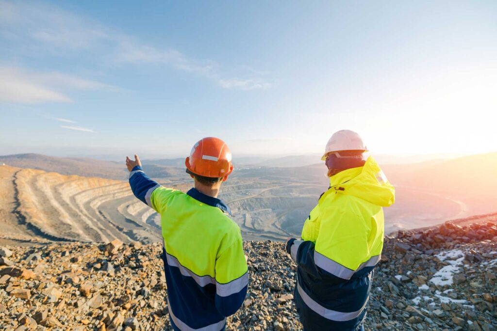 Miners overlooking a large mine