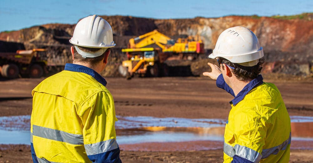 Men at a mine site pointing at a truck